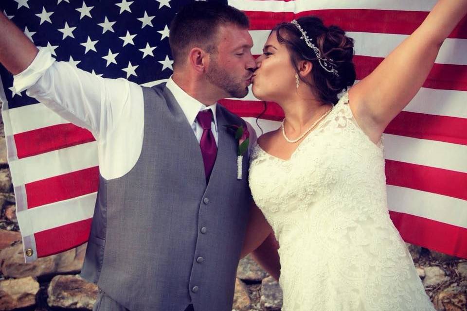 Newlyweds and the American flag | Gown: Casablanca