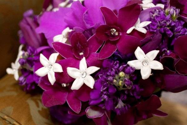 A purple-lover's dream!  Cattleya orchid, dendrobium orchids, stock, roses, stephanotis