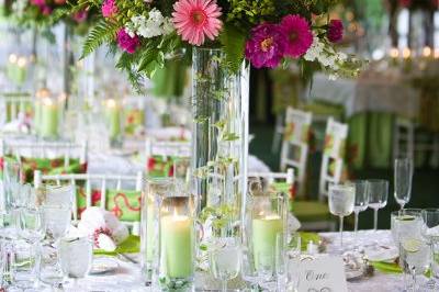 Lovely tent wedding.... bright pinks and greens atop a cylinder of floating orchids.... It was magical!