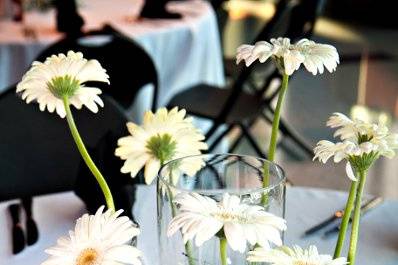 Wonderful simplicity..... a group of bud vases, each with a single flower, surrounding a floating candle!   Each table had a different flower featured....
M&T Bank Stadium