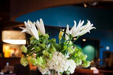 Wonderful simplicity..... a group of bud vases, each with a single flower, surrounding a floating candle!   Each table had a different flower featured....
M&T Bank Stadium