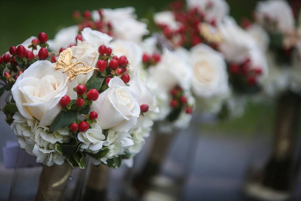Roses, hydrangea and hypericum berries, with a special accent of broaches supplied by the Bride!