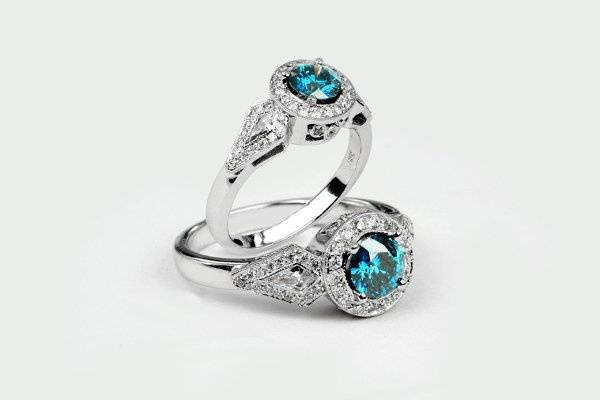 Blue Diamond center with white diamonds around. Designed by Calla Gold Jewelry