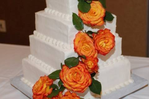 4-tier wedding cake with orange flowers