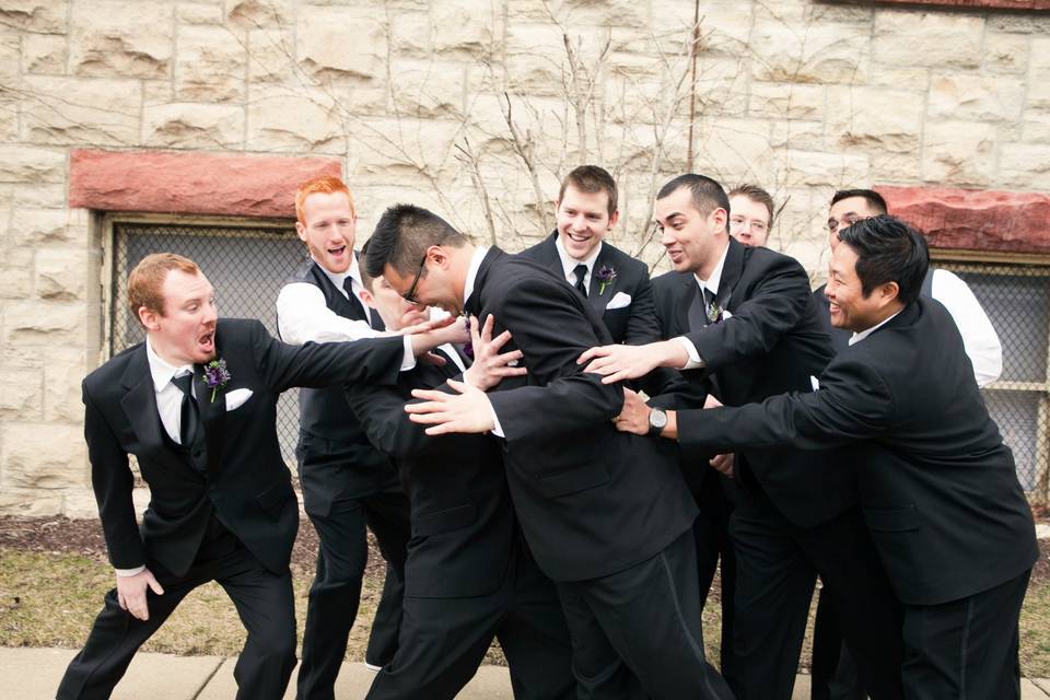 Groomsmen stopping groom