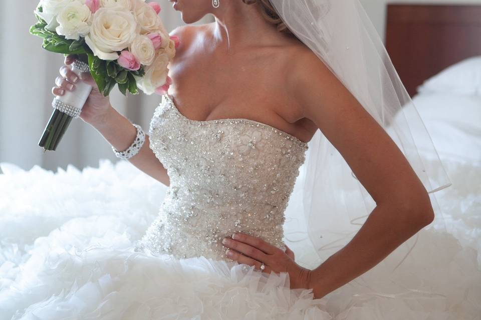 Bride smelling flowers