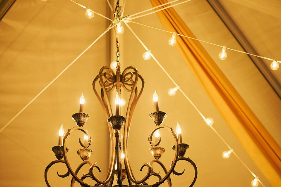 Cafe string lights and wrought iron chandeliers
Photo provided by Elle Michelle Photography