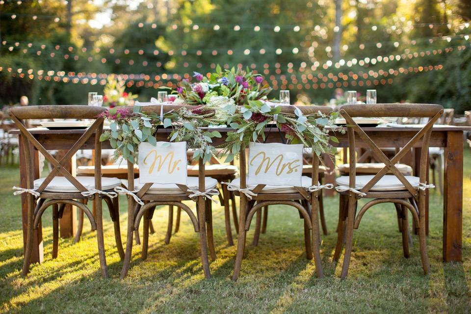 Head table with farm table and crossback chairs at Burge Plantation in Monroe, GA.