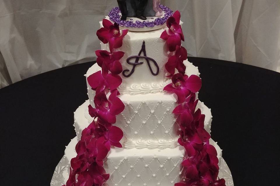 Aisle designed wedding cake with figurines