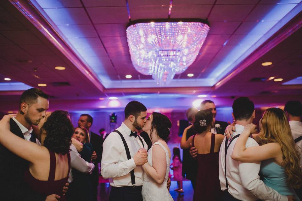 Newlyweds kissing on the dance floor