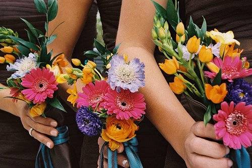 To complement the bride's bouquet, the attendants carried similar, more colorful bouquets also in a custom designed bouquet holder made from their chocolate dress fabric and tied with the aqua ribbon.