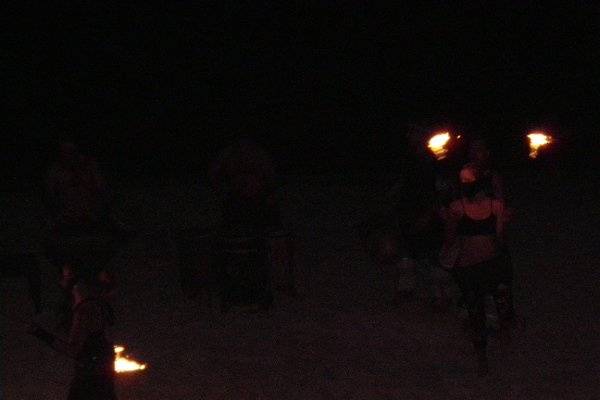 Fire dancers on the beach can perform for your wedding guests.