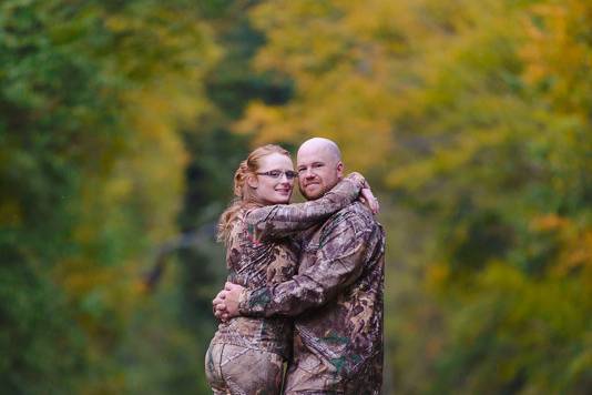 Engagement portraits in rustic setting with camo