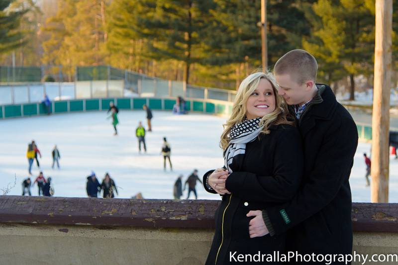 Engagement portraits in the winter snow of Pittsburgh in front of skating rink.