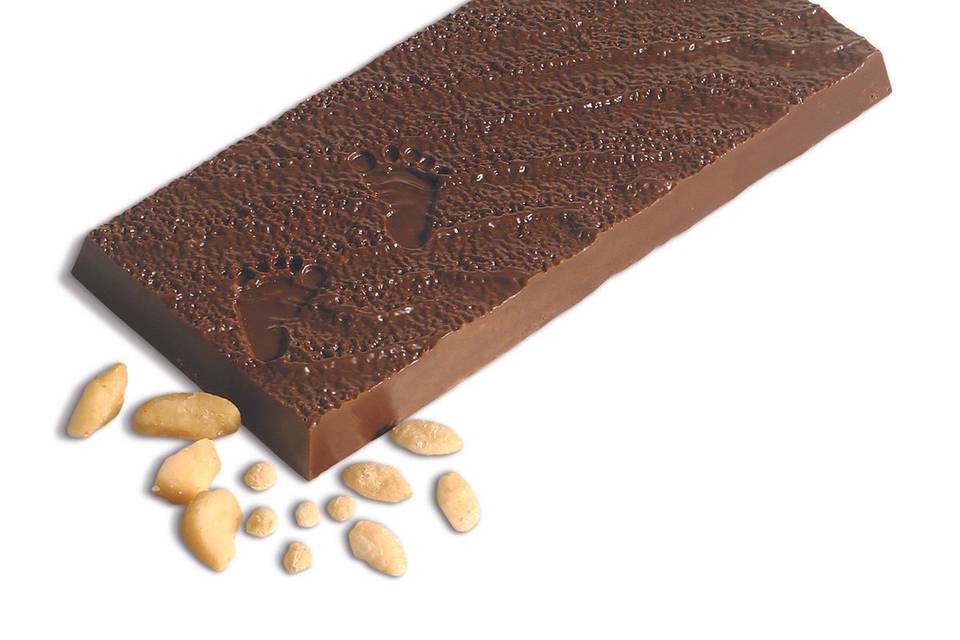 This Footprints in the Sand premium chocolate bar features  savory macadamia nut and crisps.  It is made with our special house blend of milk and dark chocolate.