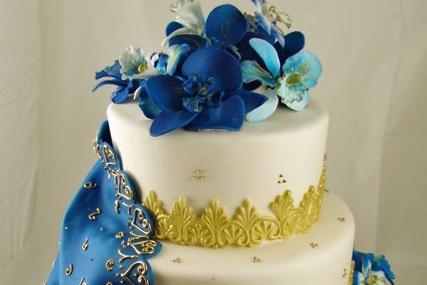 Wedding cake with blue flowers on top