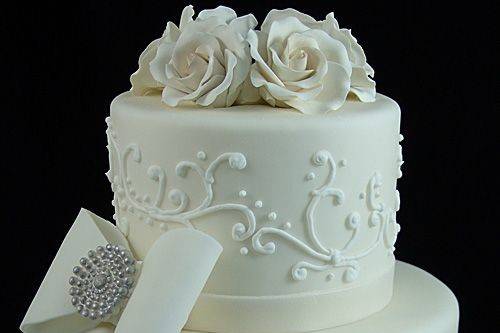 All white wedding cake with bow on top