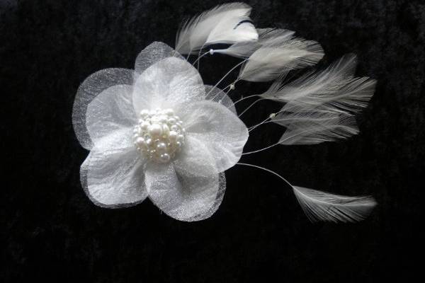 White handmade flower with pearl beading and white feathers