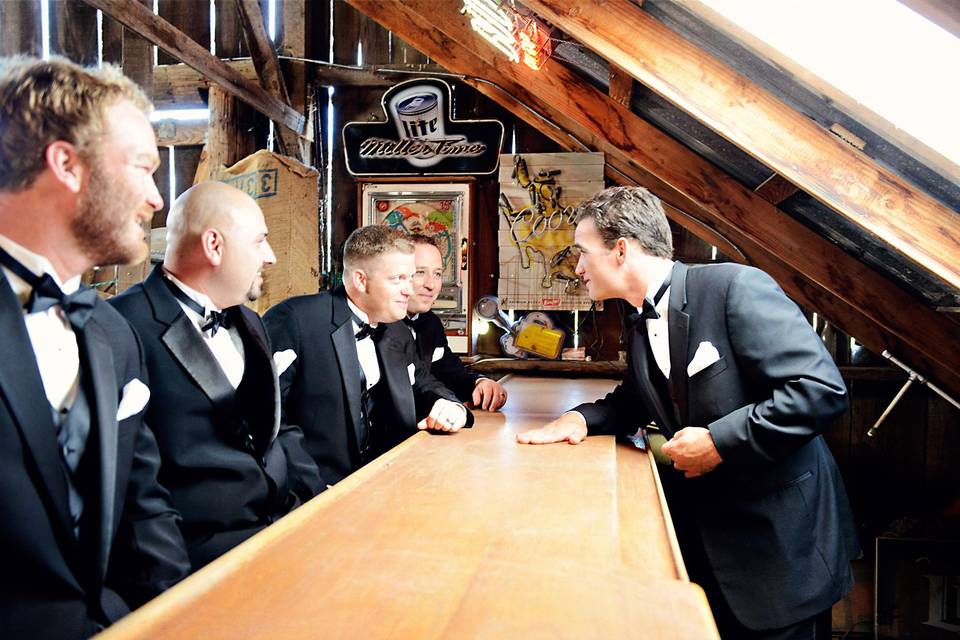 Groom and groomsmen at the bar upstairs in barn