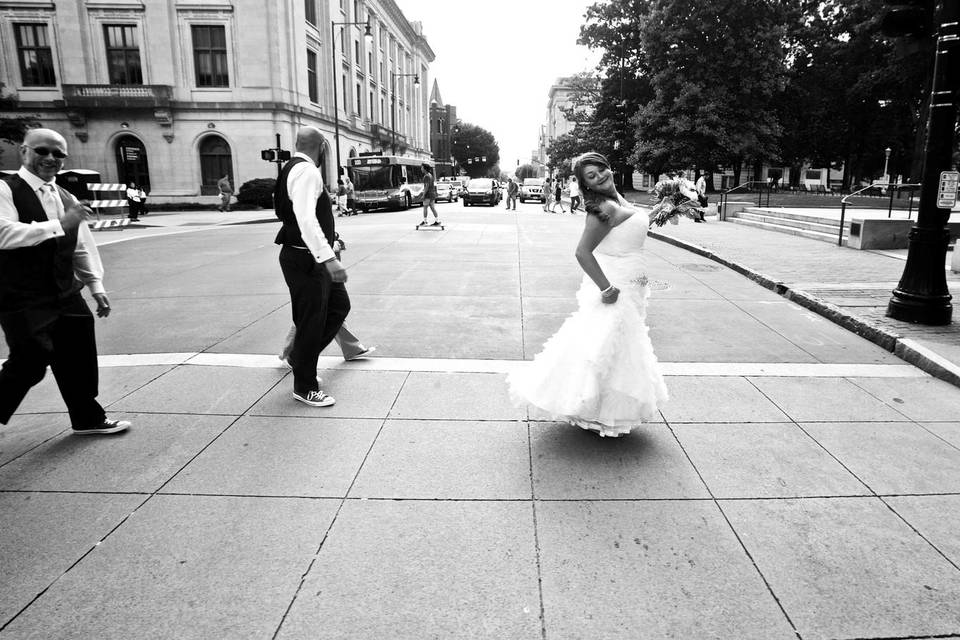 Bride walking across the street in Raleigh, N.C. by www.stanchambersjr.com.