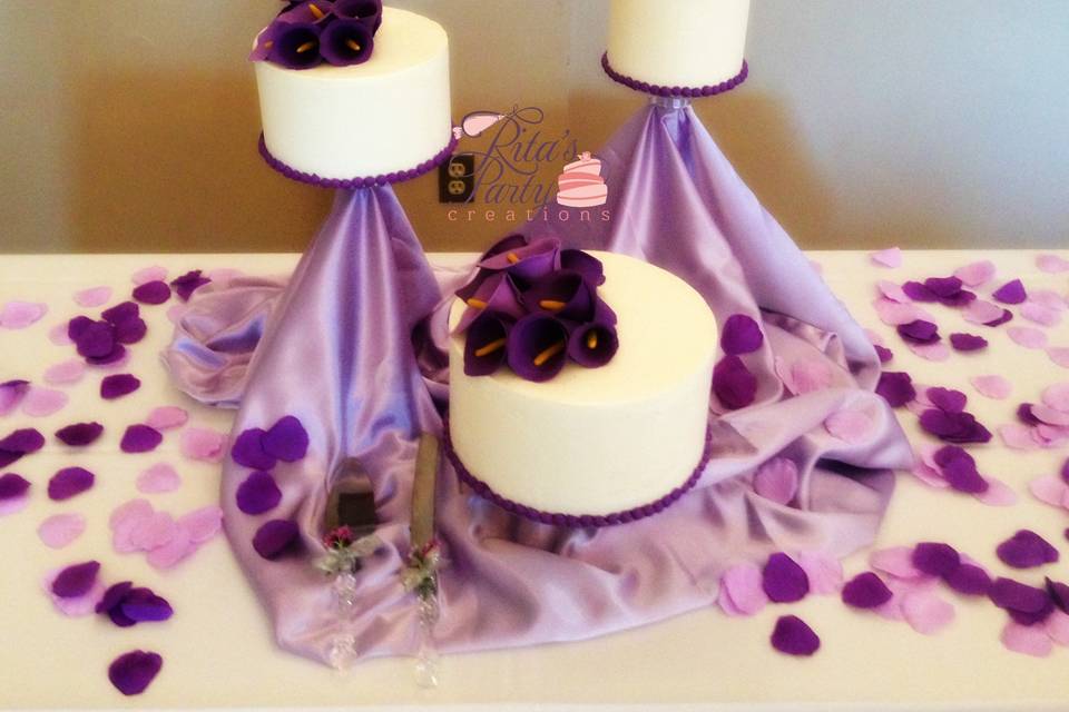 Three separate tiers with vanilla buttercream. The cakes are all topped with purple calla lilies.