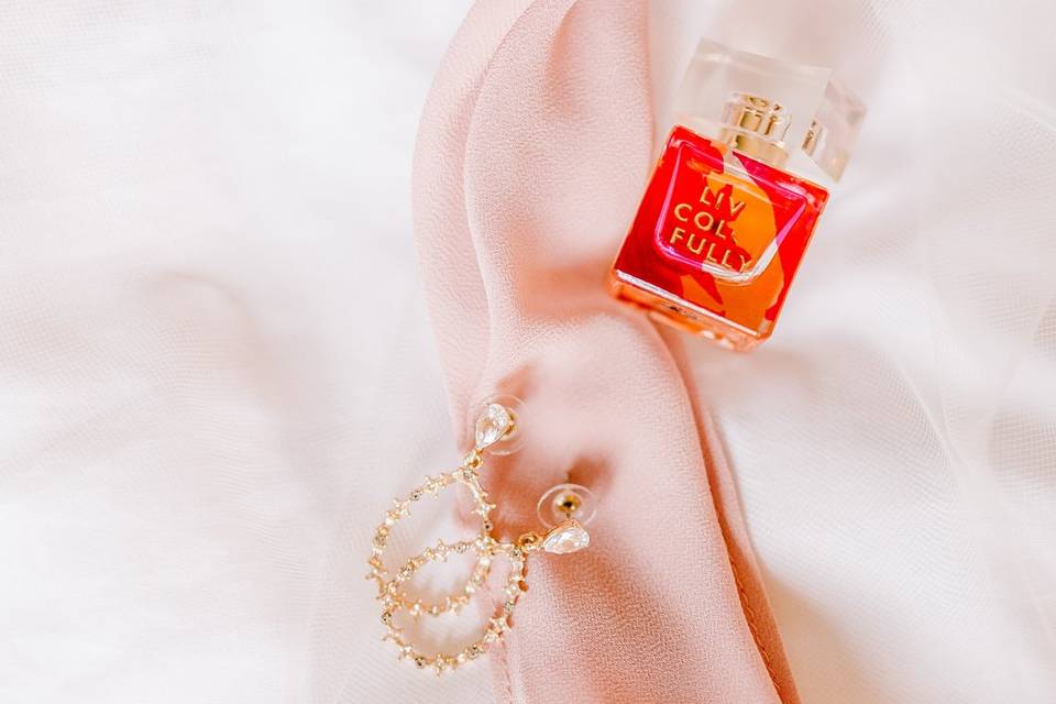 Detail of perfume and earings