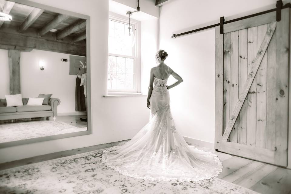 Bride standing by window