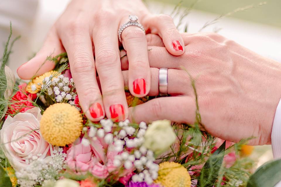 Couples hands over flowers