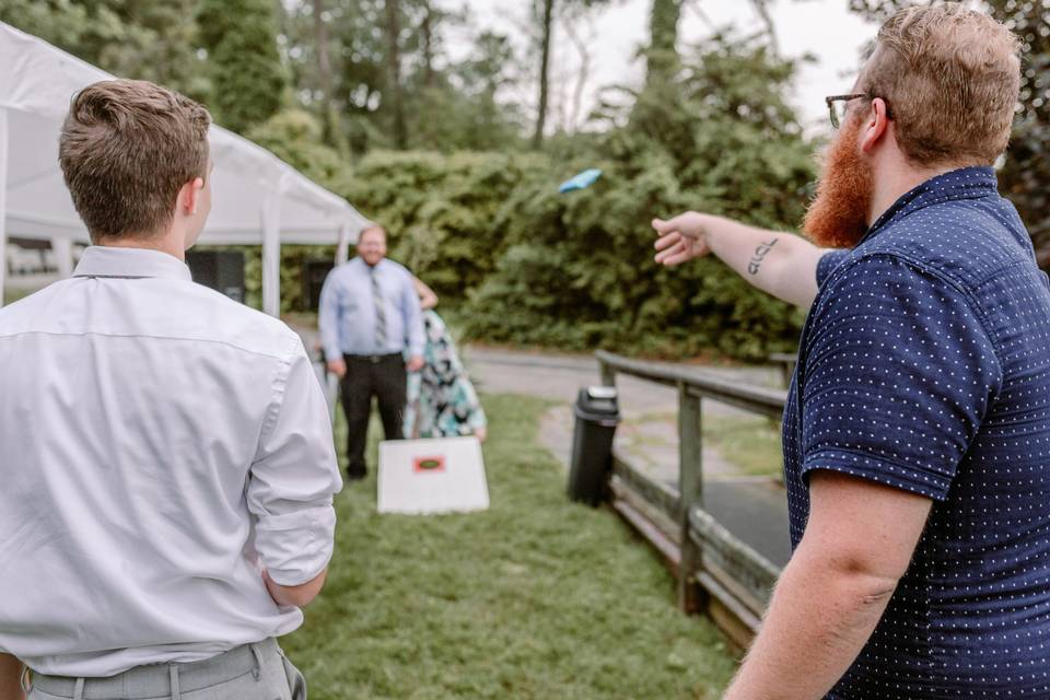 Guests throwing corn hole bag