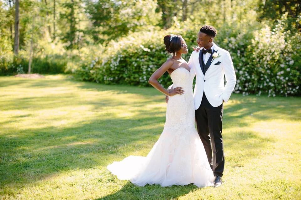 Groom in a stylish white tuxedo with his bride.