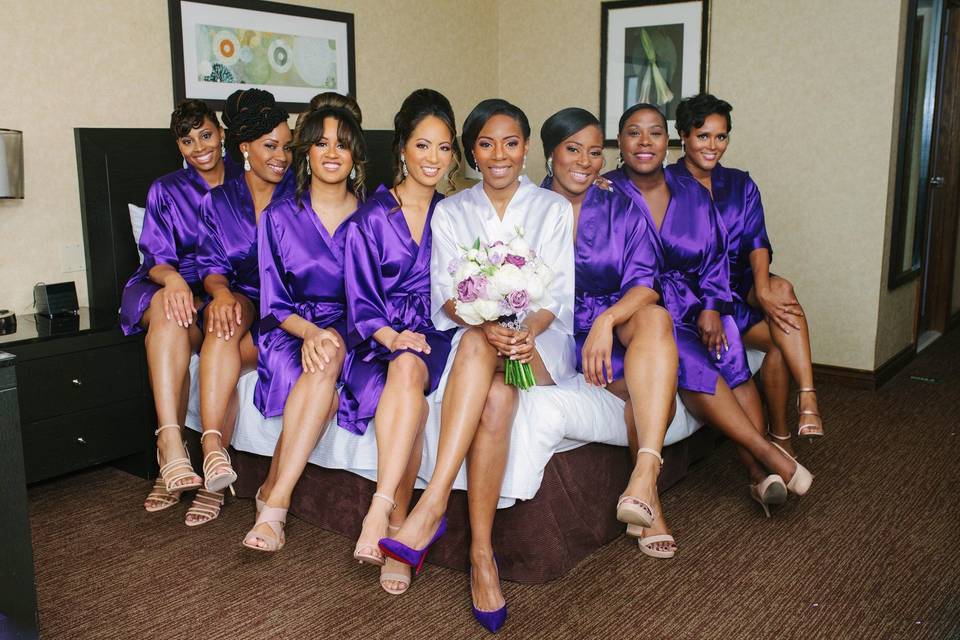 Bridesmaids getting ready in purple robes at the W Atlanta Downtown.