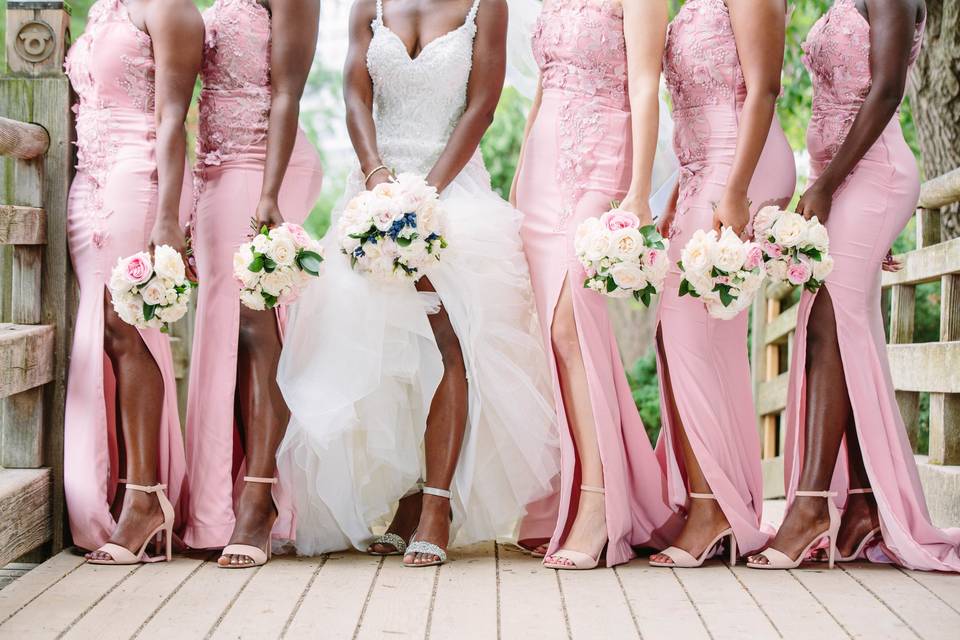 Bridesmaids wearing pink on the bridge at the Atlanta Botanical Garden.