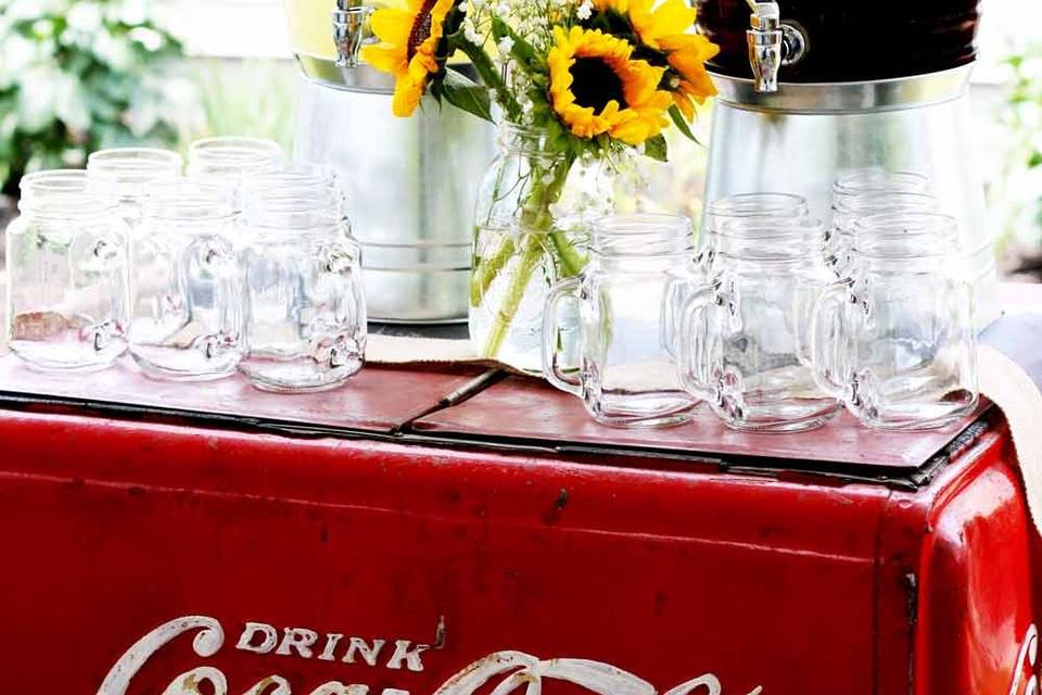 Our Full-Service Summer Grill menu includes Fresh Brewed Iced Tea and Lemonade. We provided this vintage Coca Cola cooler to display the beverages.