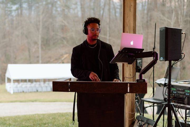 DJ with event tent in back
