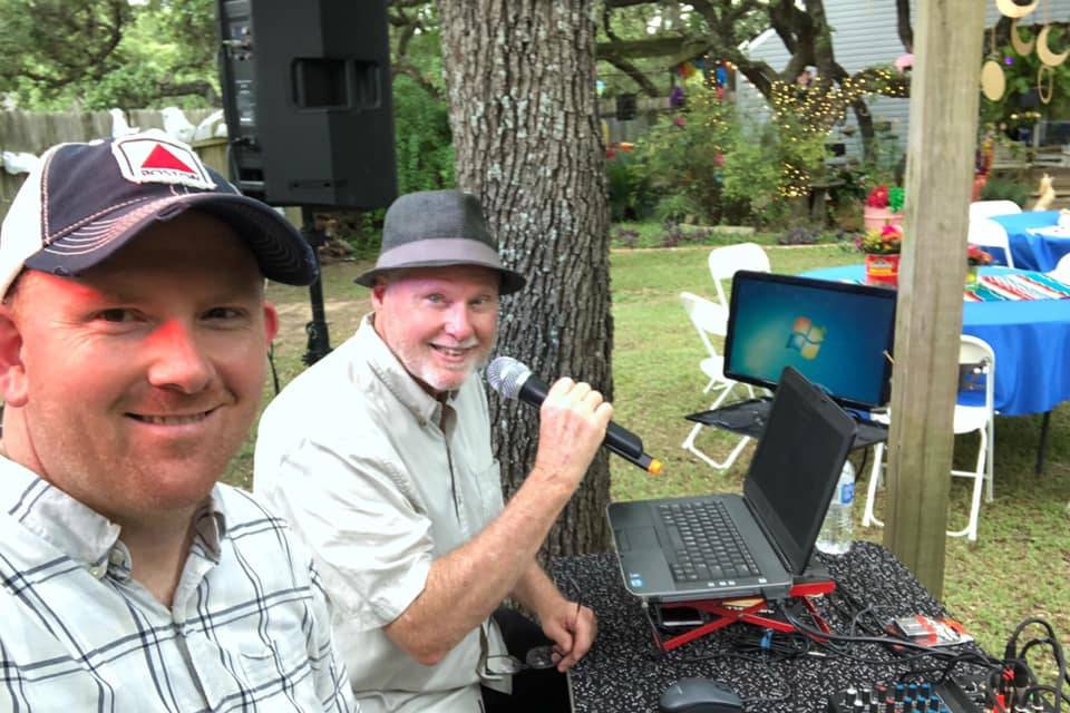The DJ's at an outdoor party.