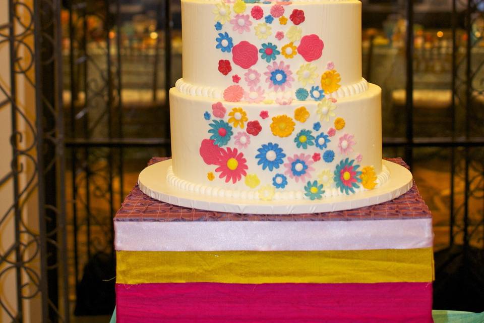 4 Tier buttercream cake with sugar flowers decorating the cake