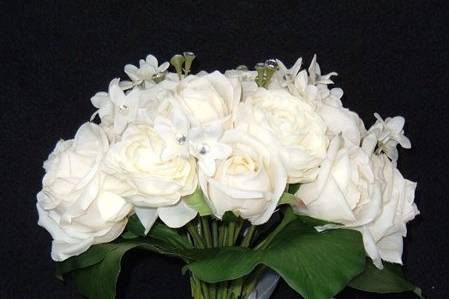 9x12 inches in ivory with approximately 16 faux stones, intertwined in the flowers. Tied with a white ribbon