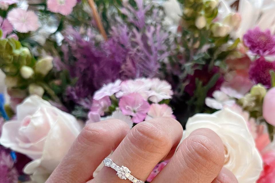 round-diamond-engagement-ring-on-hand-wedding-bouquet-haejin-jewelry-brooklyn.jpg