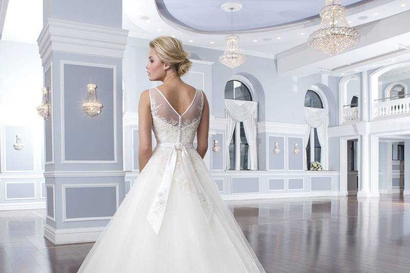 Style-Back 6294
This strapless neckline is asymmetrically draped in charmeuse with an inverted basque waistline that sits atop a circular cut skirt. The gown has charmeuse buttons covering the back zipper and lead into a chapel length train.