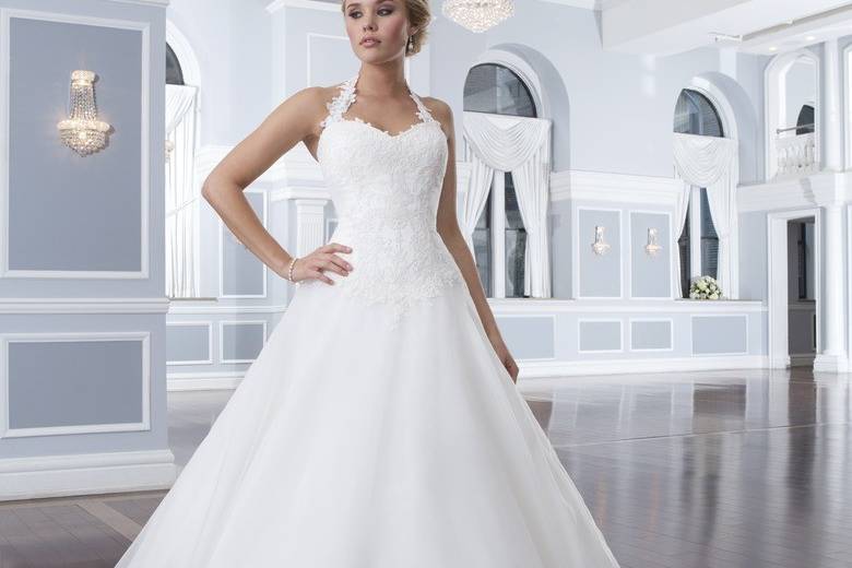 Style 6300
This tulle and beaded lace A-line gown has an illusion Sabrina neckline and chapel length train. Satin buttons enclose the illusion back neckline and zipper.