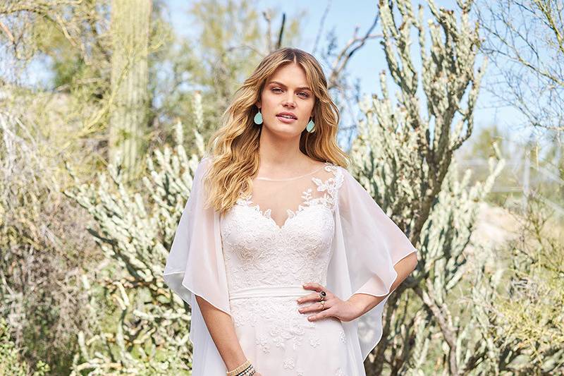 Lillian West	6517	<br>	Organic and ethereal soft chiffon flows from the shoulders of this illusion Sabrina neckline. Soft lace appliques adorn the bodice and skirt accented by a self-tie chiffon belt. Buttons finish the romantic deep illusion back.