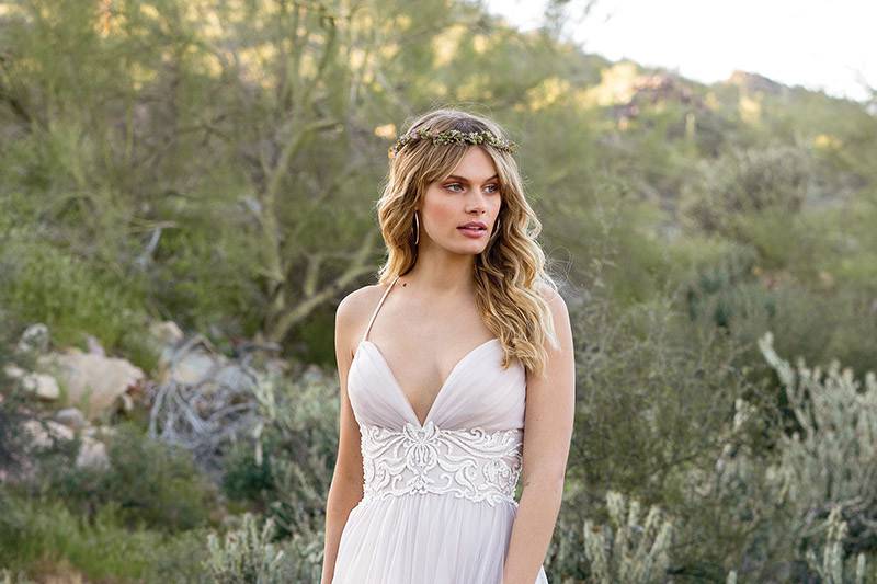 Lillian West	6530	<br>	Light and floating.  This empire tulle gown is accented by hand beaded lace at the waistline. Soft spaghetti straps cross the back of the gown with finished buttons to cover the zipper closure.