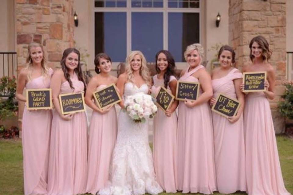 Bride and her bridesmaids with signs