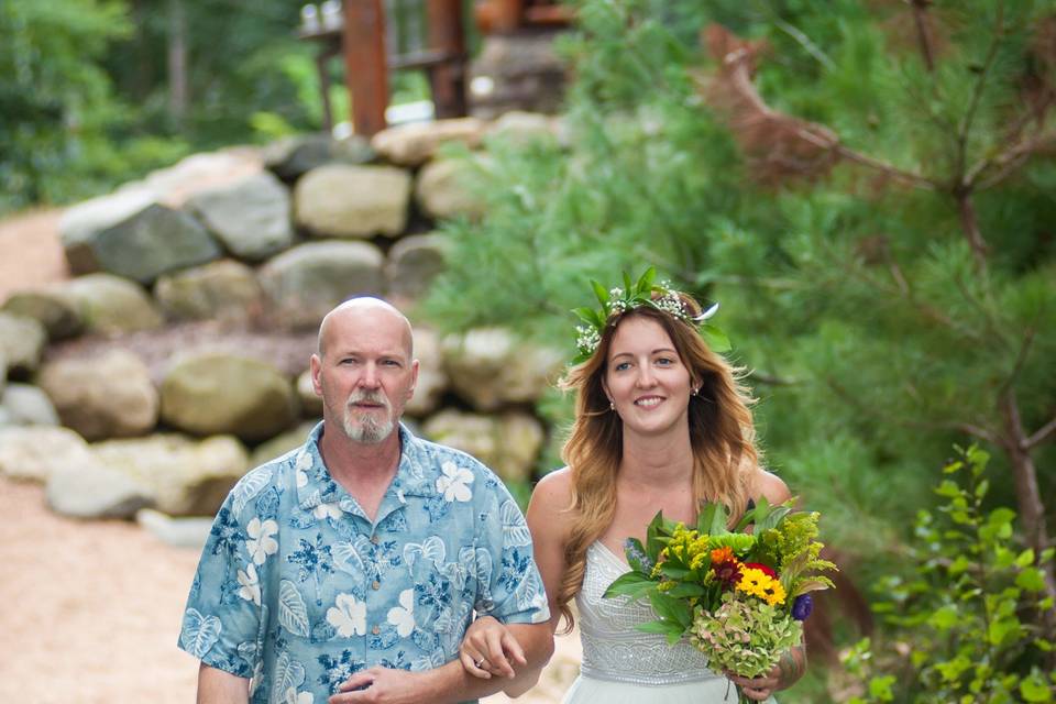 Bride and her father making their way from the lodge to the wedding on the beach