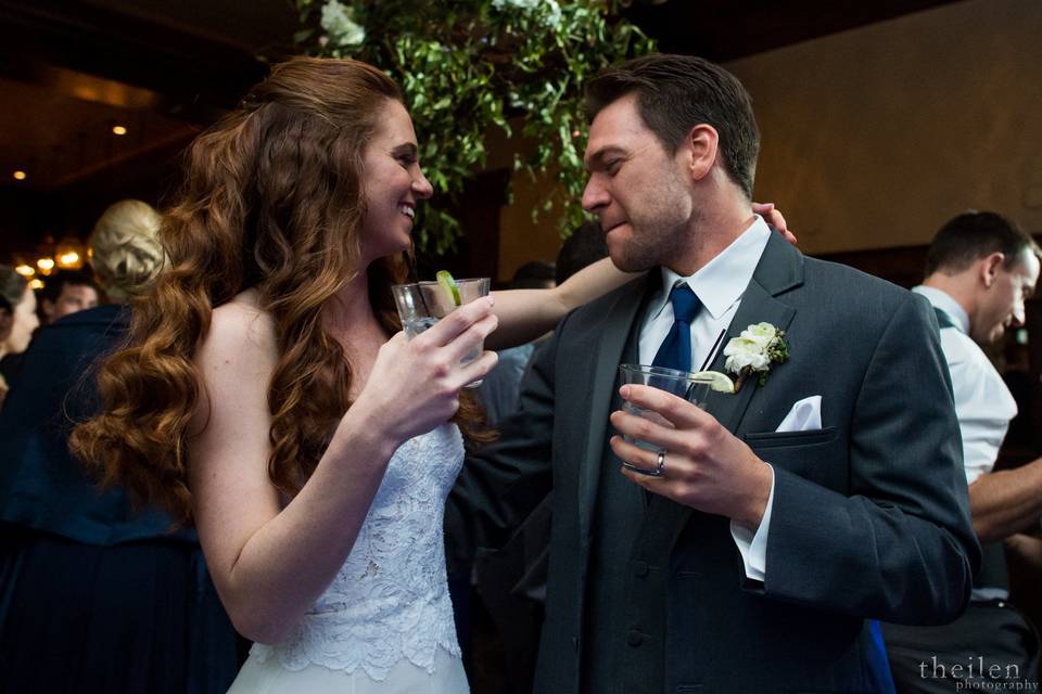 Newlyweds sharing drinks on the dance floor