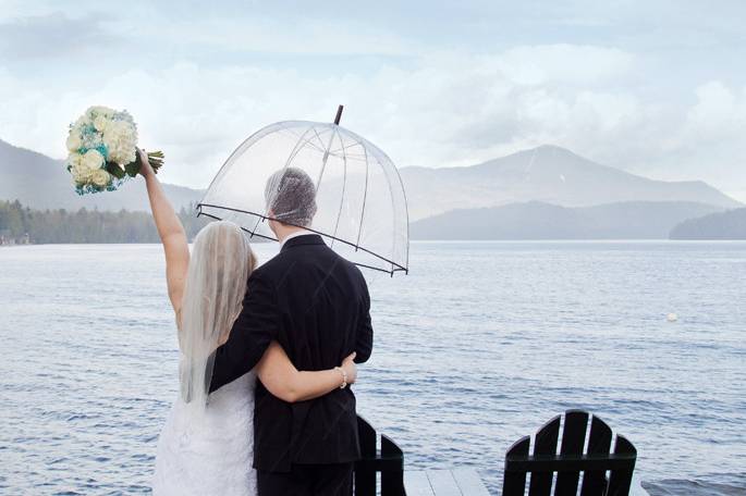 Bride and Groom with an umbrella, toughing the rain