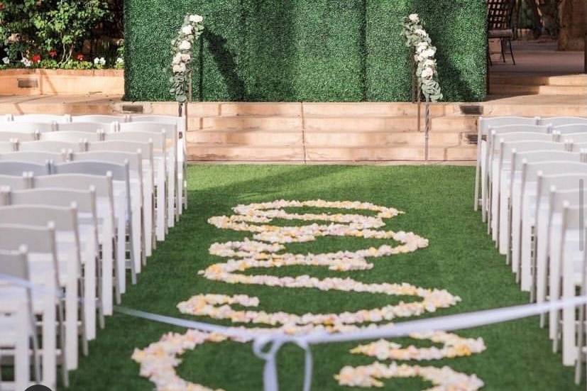 White chairs with greenery