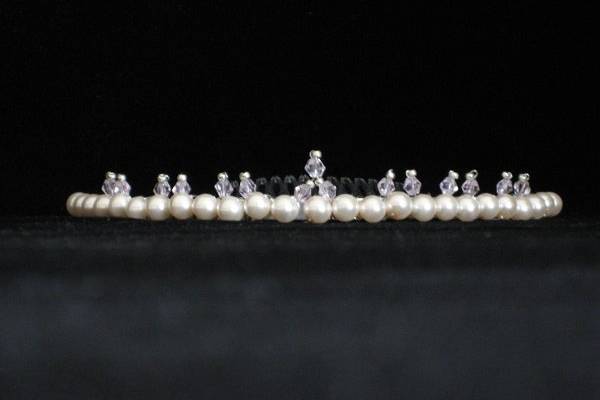 This dainty tiara features a Swarovski Pearl and Swarovski AB Crystal combination and will create a lovely accent for any style of gown.
Warning: you may be mistaken for a real princess! $75