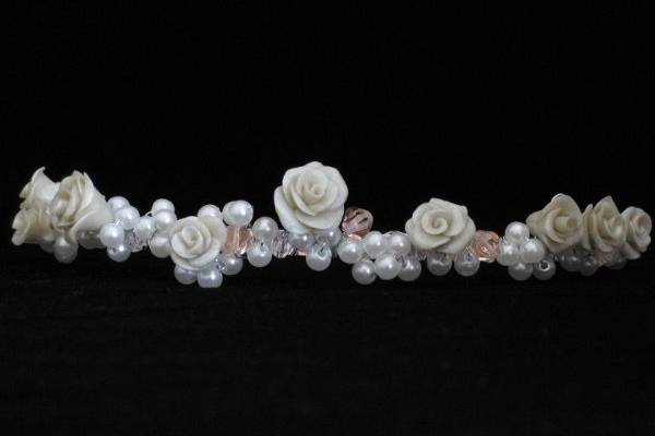 This timeless tiara features eleven hand-crafted clay roses delicately nestled among clusters of Swarovski Pearls and Crystals. $125