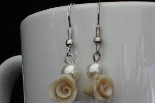 These unique earrings are made with a Swarovski Pearl and a hand-sculpted clay rose. $28